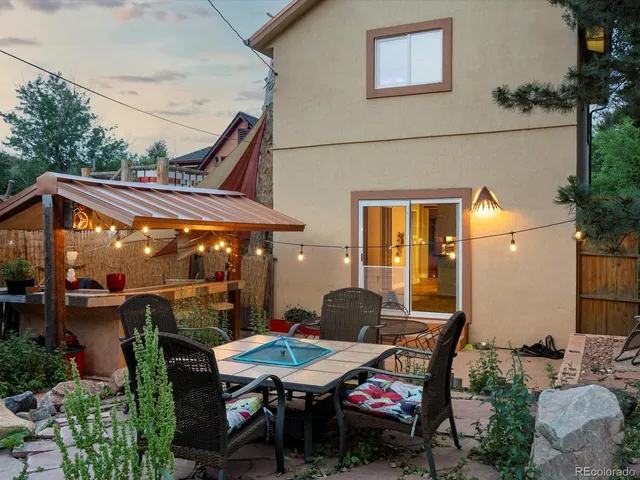 a view of a houses with a lush green hillside