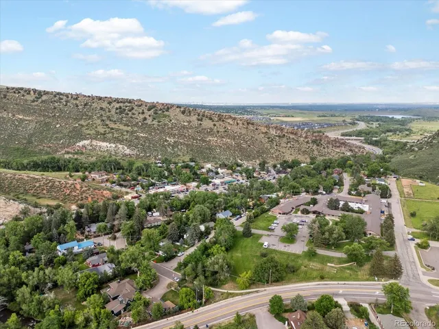 an aerial view of residential building and trees around