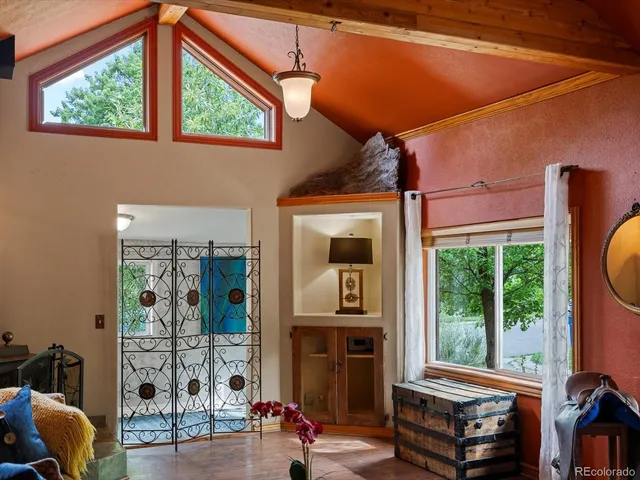 a view of a living room with furniture and large windows
