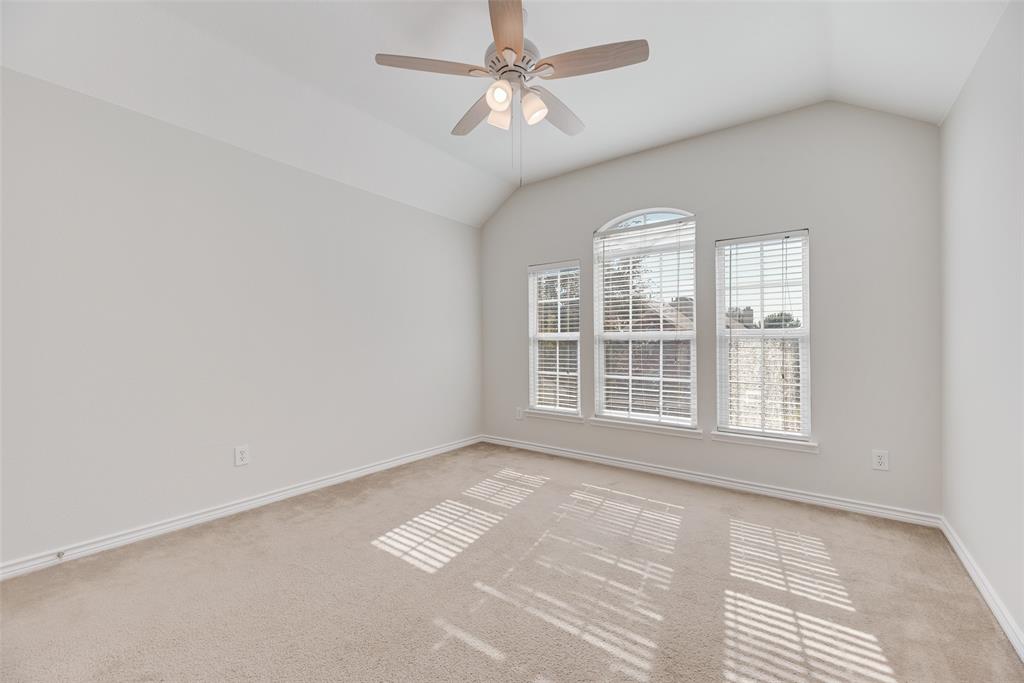 8004 Laughing Waters Trail McKinney, TX 75070 - Photo 11 of 24 an empty room with windows and ceiling fan