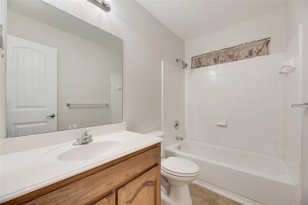 8004 Laughing Waters Trail McKinney, TX 75070 - Photo 13 of 24 a bathroom with a sink a toilet and a bathtub