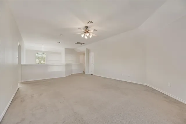 a view of empty room with a ceiling fan