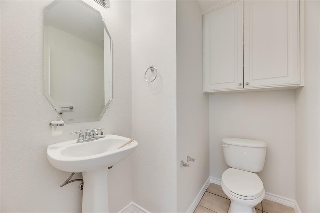 8004 Laughing Waters Trail McKinney, TX 75070 - Photo 18 of 24 a bathroom with a toilet sink and a mirror