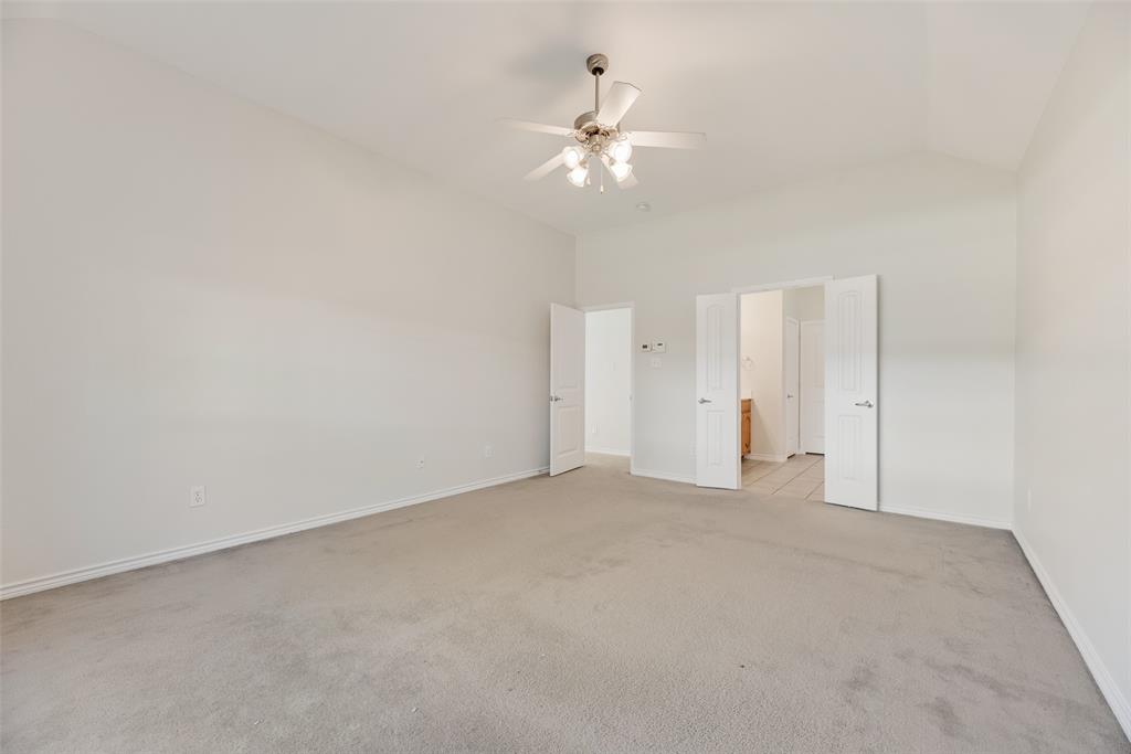 8004 Laughing Waters Trail McKinney, TX 75070 - Photo 20 of 24 a view of an empty room with a chandelier fan