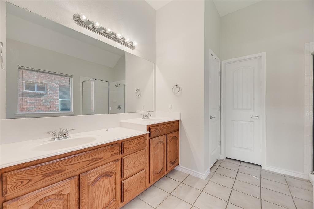 8004 Laughing Waters Trail McKinney, TX 75070 - Photo 21 of 24 a spacious bathroom with a double vanity sink and a mirror