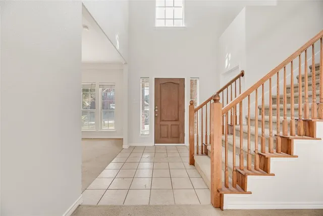 a view of an entryway with wooden floor and door