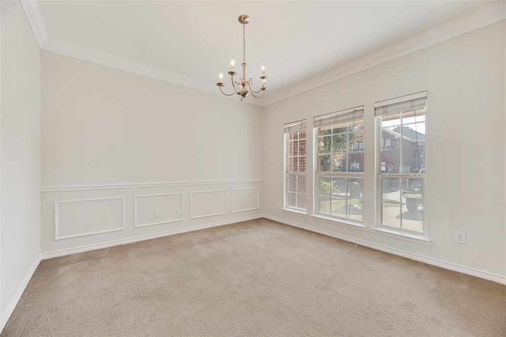 8004 Laughing Waters Trail McKinney, TX 75070 - Photo 24 of 24 en empty room with windows and chandelier
