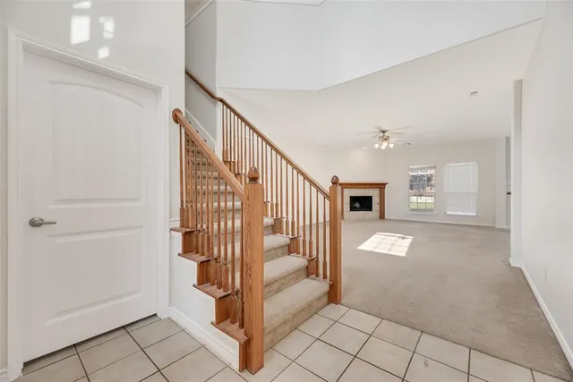 a view of a livingroom with entryway and stairs