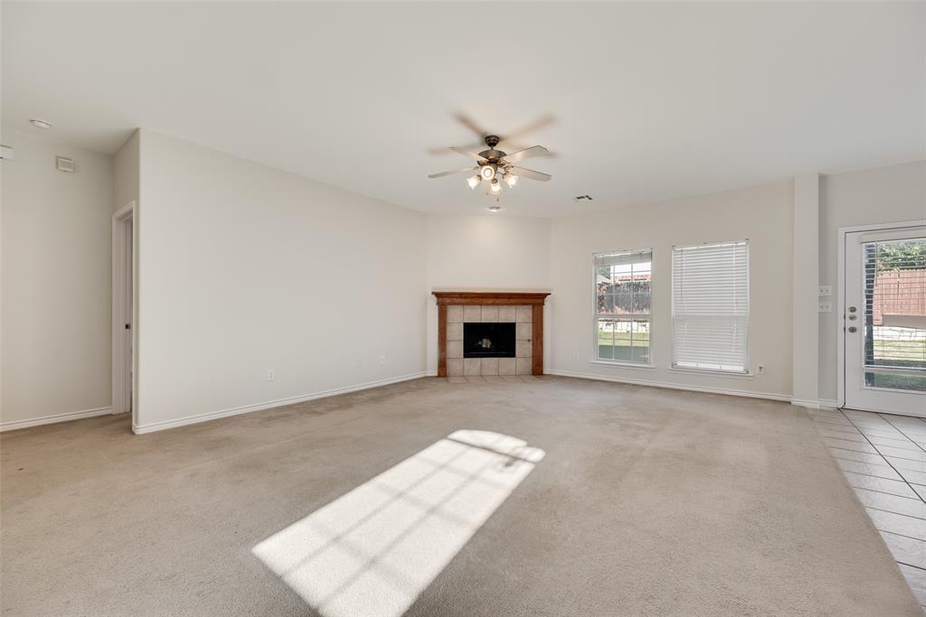8004 Laughing Waters Trail McKinney, TX 75070 - Photo 4 of 24 an empty room with windows and fireplace