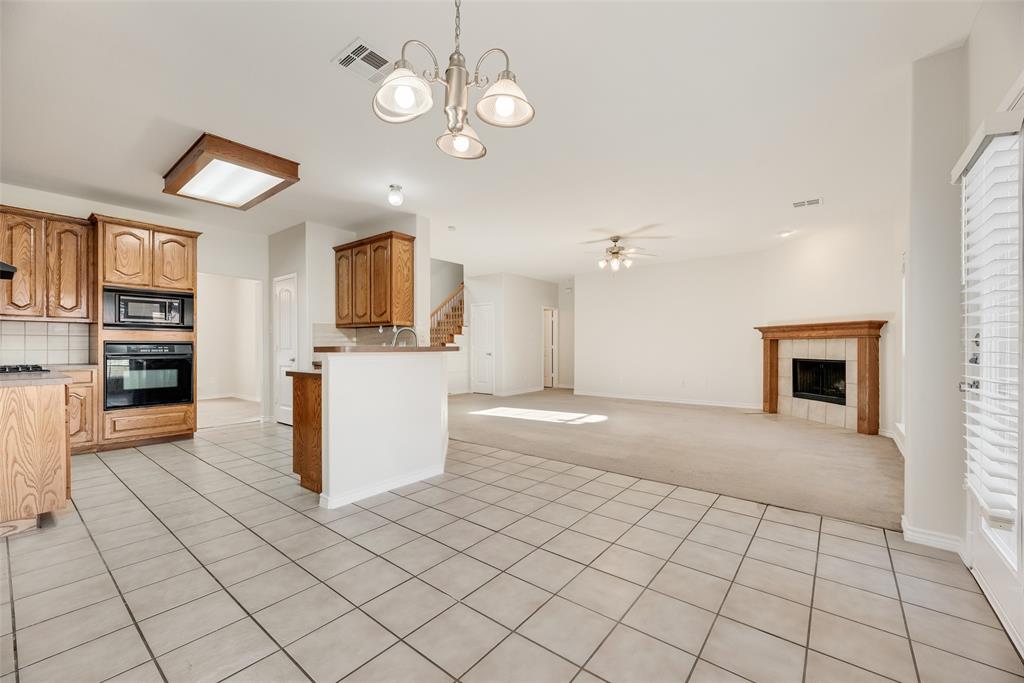 8004 Laughing Waters Trail McKinney, TX 75070 - Photo 7 of 24 a view of a kitchen with microwave and cabinets