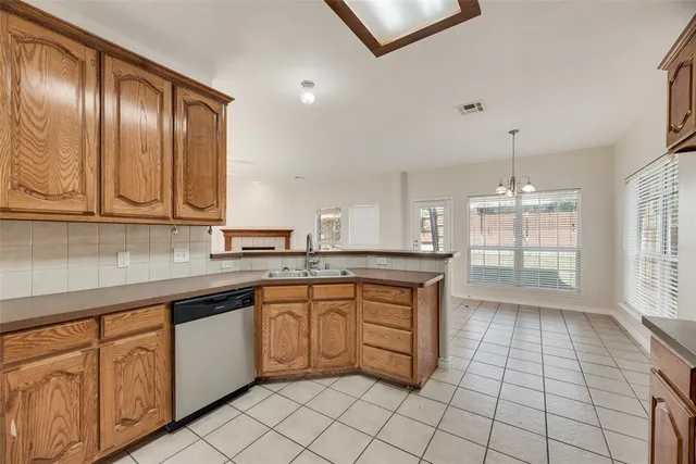 a kitchen with a sink window and cabinets