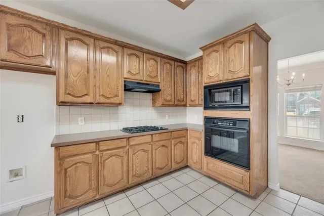 a kitchen with stainless steel appliances granite countertop a stove microwave and cabinets