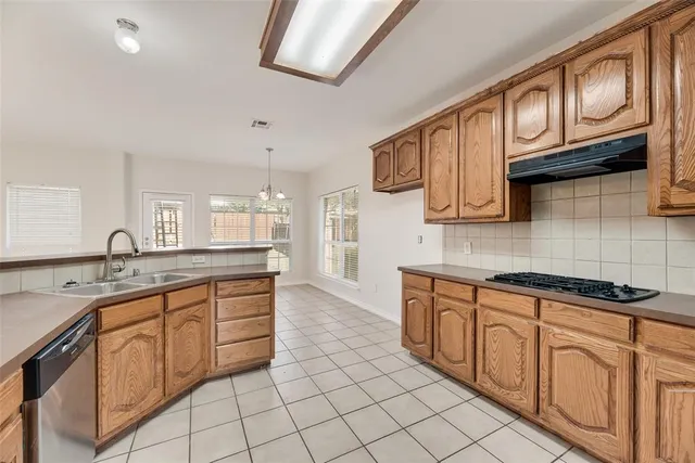 a kitchen with stainless steel appliances granite countertop a sink and cabinets