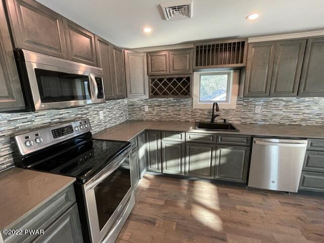 2 Hudson Street Hawley, PA 18428 - Photo 11 of 43 a kitchen with stainless steel appliances granite countertop a stove a sink and a microwave