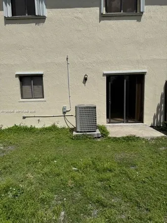 a backyard of a house with lots of green space and plants