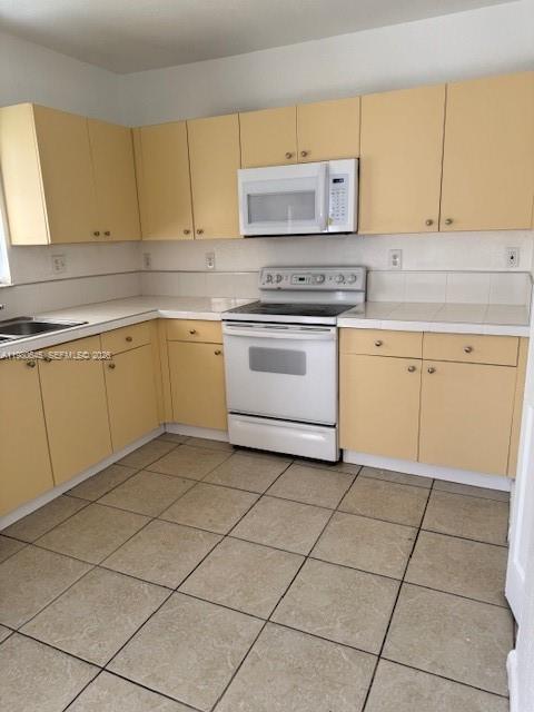28107 Southwest 143rd Court, Unit 28107 Homestead, FL 33033 - Photo 6 of 10 a kitchen with cabinets and appliances