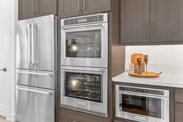 a kitchen with granite countertop white cabinets and white appliances