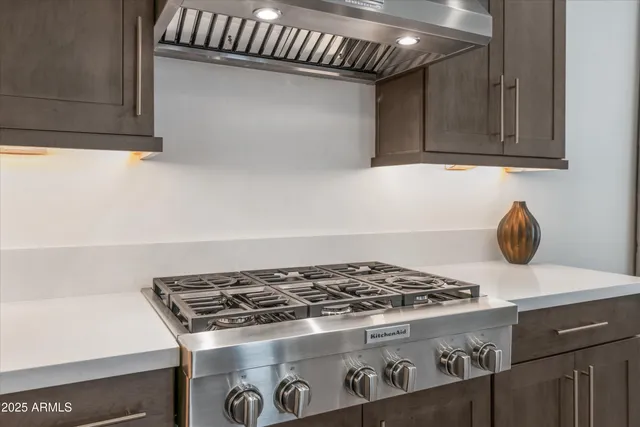 a stove top oven sitting inside of a kitchen
