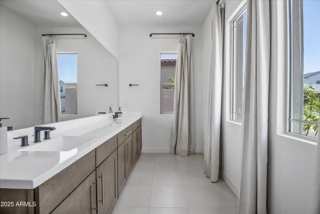 a bathroom with 2 sink and a mirror