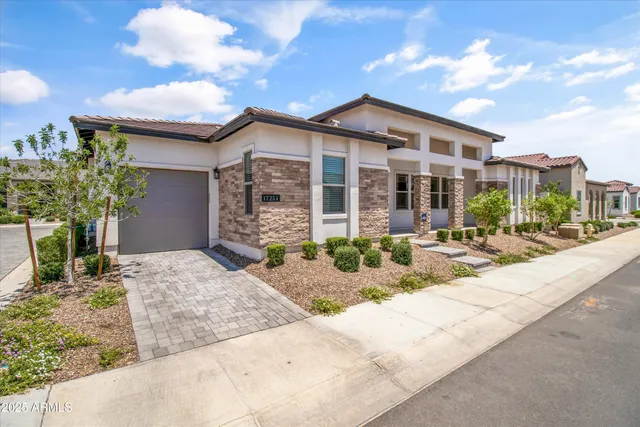 a view of a house with backyard and sitting area