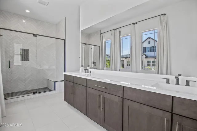 a bathroom with double vanity sinks and a mirror