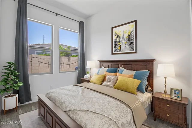 a bedroom with a bed and a potted plant next to a window