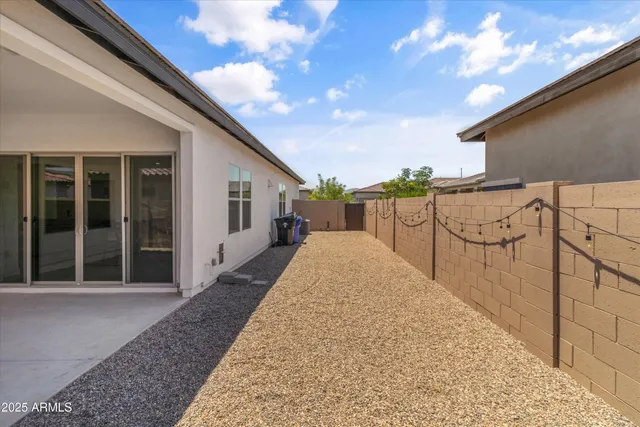 a view of backyard with large trees and barbeque oven