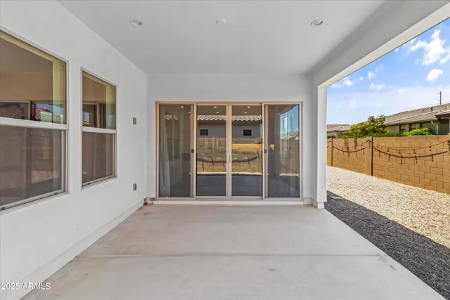 a view of an empty room with a balcony and large window