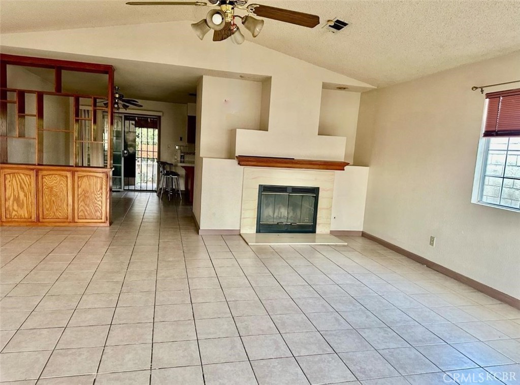 725 18th Place Delano, CA 93215 - Photo 8 of 36 a view of a livingroom with a fireplace and window