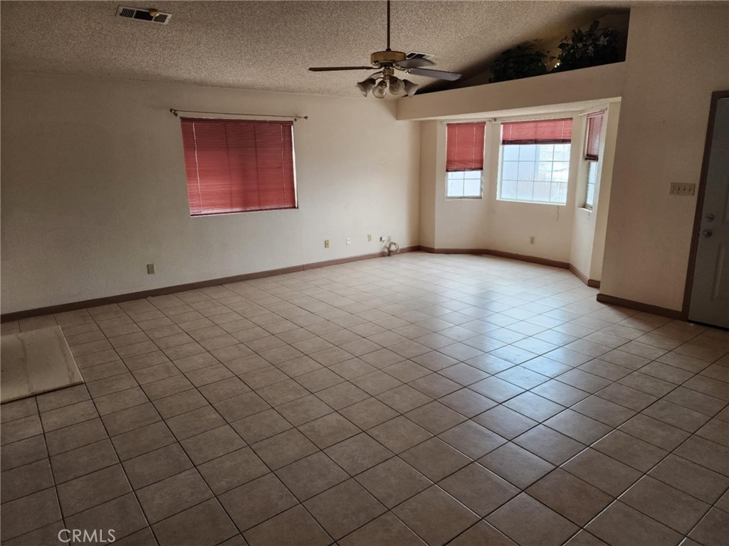 725 18th Place Delano, CA 93215 - Photo 10 of 36 an empty room with windows