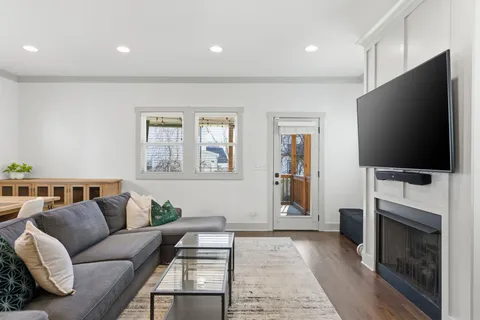 a living room with fireplace furniture and a flat screen tv