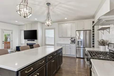 a kitchen with stainless steel appliances a sink stove and refrigerator