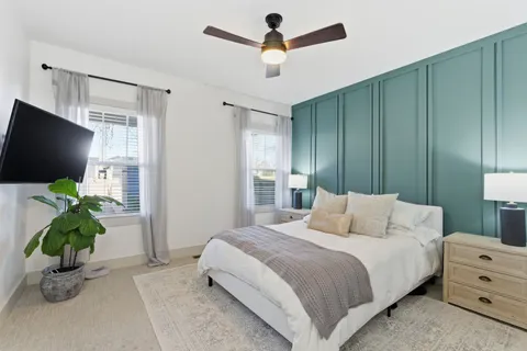 a bedroom with a bed and a chandelier