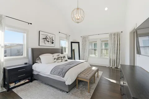 a spacious bathroom with a double vanity sink mirror and bathtub