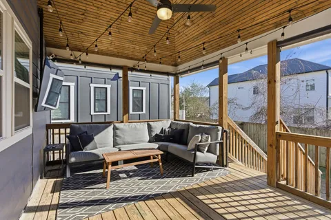 a view of a balcony with wooden floor