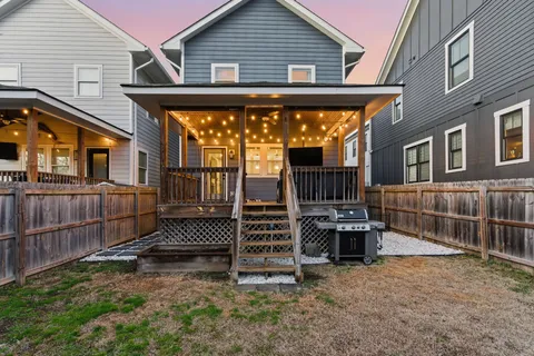 a view of a house with wooden floor and a fence