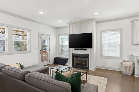 a living room with furniture a fireplace and a flat screen tv