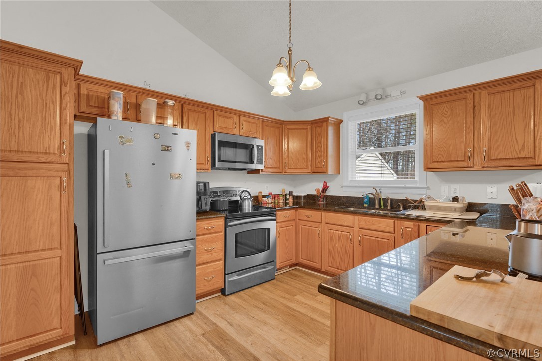 8561 Roundabout Road Henrico, VA 23231 - Photo 32 of 42 a kitchen with stainless steel appliances granite countertop a refrigerator stove microwave and sink