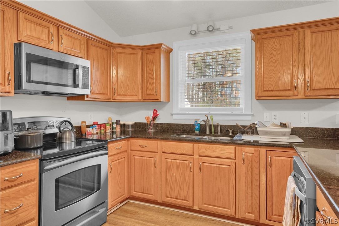 8561 Roundabout Road Henrico, VA 23231 - Photo 33 of 42 a kitchen with granite countertop a sink cabinets stainless steel appliances and a window