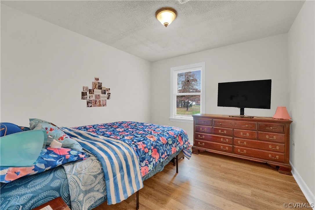 8561 Roundabout Road Henrico, VA 23231 - Photo 37 of 42 a bedroom with a bed and a flat screen tv