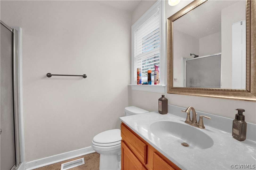 8561 Roundabout Road Henrico, VA 23231 - Photo 39 of 42 a bathroom with a sink toilet and mirror