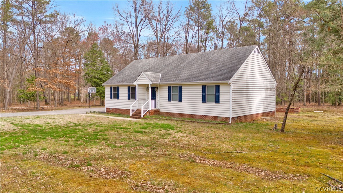 8561 Roundabout Road Henrico, VA 23231 - Photo 6 of 42 a backyard of a house with large trees and barbeque oven