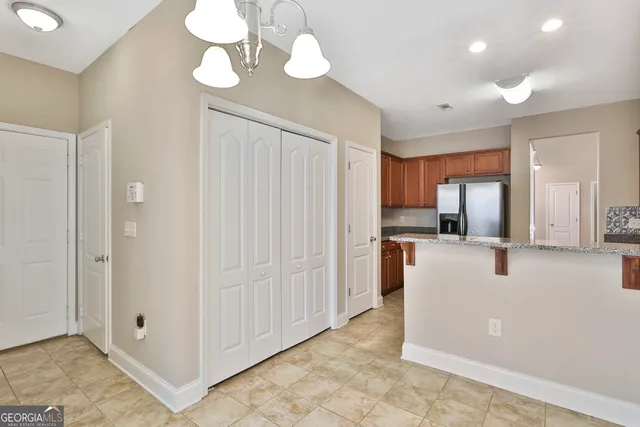 a view of kitchen with stainless steel appliances granite countertop cabinets and window