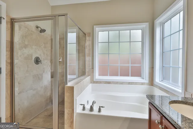 a bathroom with a bathtub and a shower