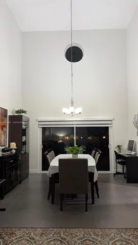 a dining room with furniture and chandelier
