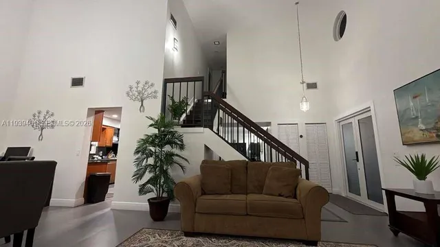 a living room with furniture and a potted plant