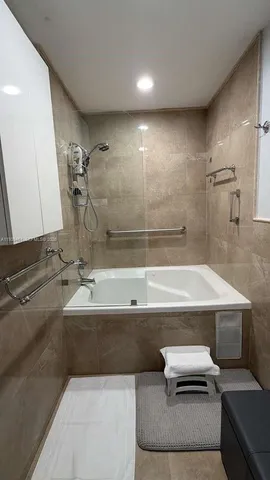 a bathroom with a bathtub and a sink