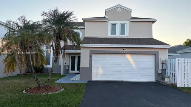 a front view of a house with a garden and yard
