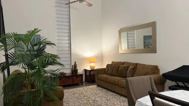 a living room with furniture and a potted plant