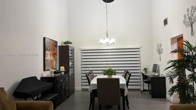 a view of a workspace with furniture and a potted plant